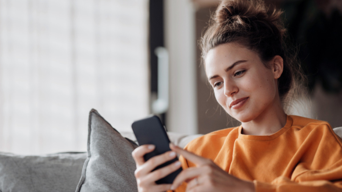 woman looks at phone